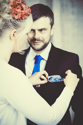 Elin straightens Fredrik's handkerchief